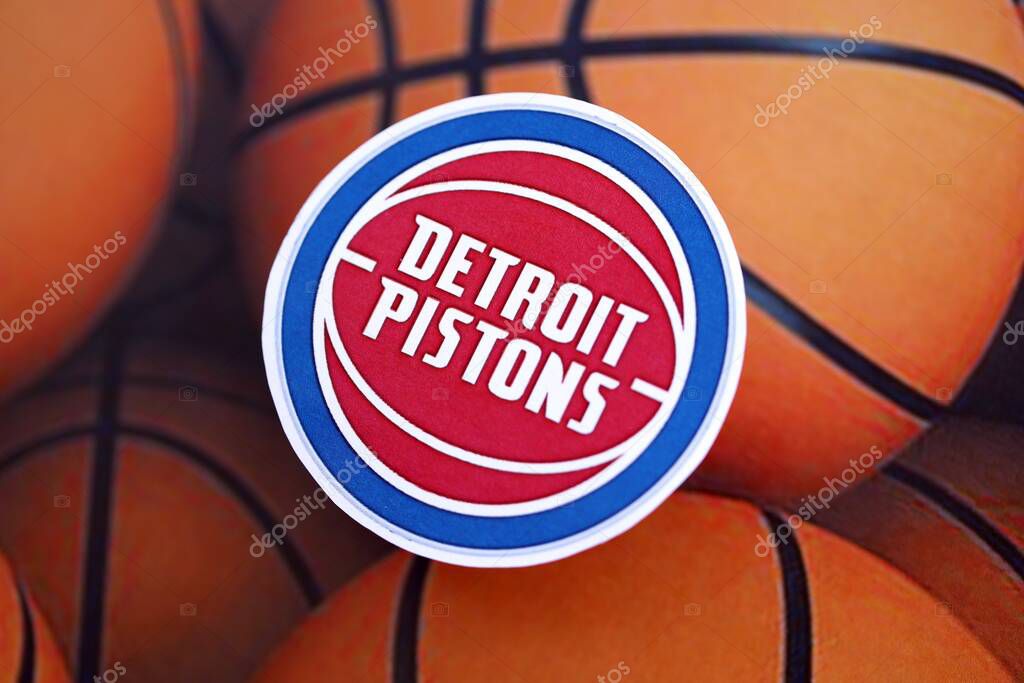 KYIV, UKRAINE - FEBRUARY 23, 2025 Detroit Pistons basketball team badge lies on basketball balls background banner