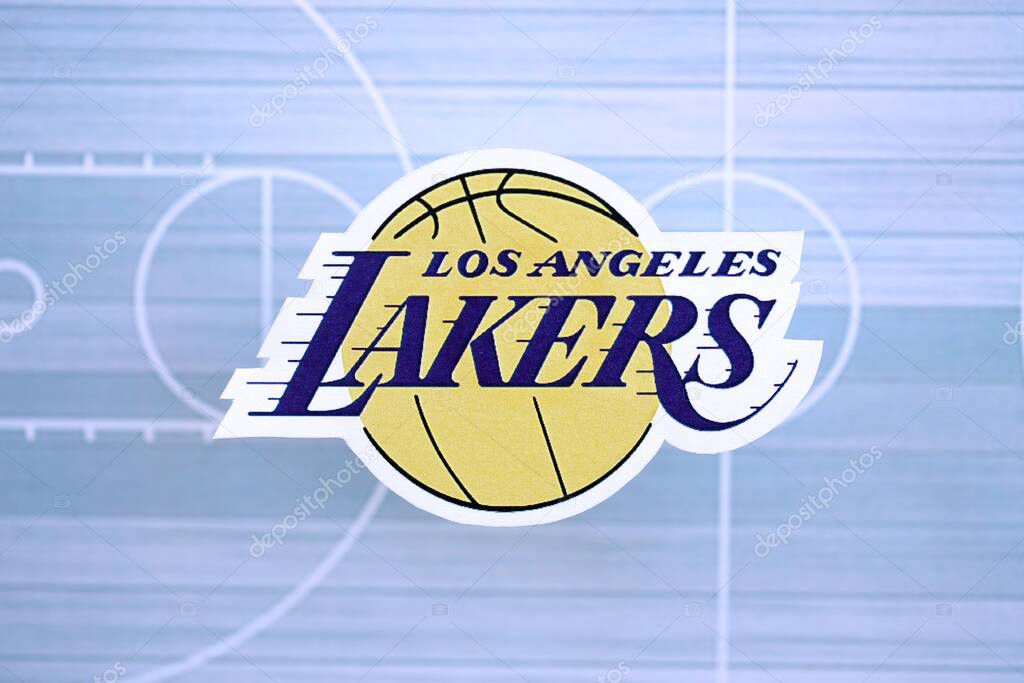 KYIV, UKRAINE - FEBRUARY 23, 2025 Los Angeles Lakers basketball team badge lies on basketball stadium map background banner