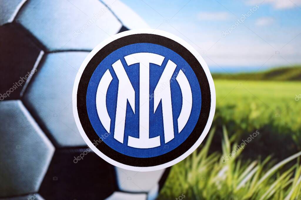KYIV, UKRAINE - FEBRUARY 23, 2025 Inter Milan FC football club badge lies on soccer ball background banner