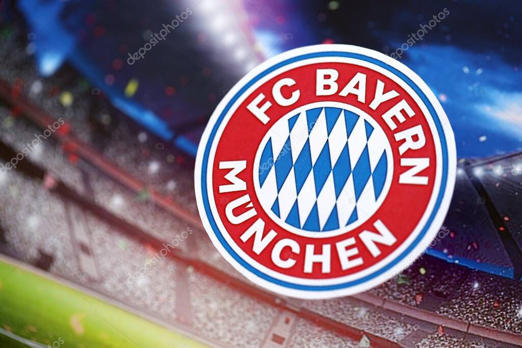 KYIV, UKRAINE - FEBRUARY 23, 2025 FC Bayern Munich football club badge lies on soccer stadium background banner
