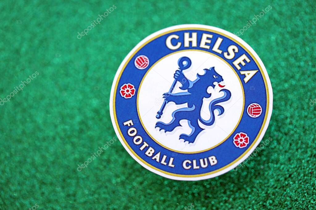 KYIV, UKRAINE - FEBRUARY 23, 2025 Chelsea FC football club badge lies on emerald green glitter background banner