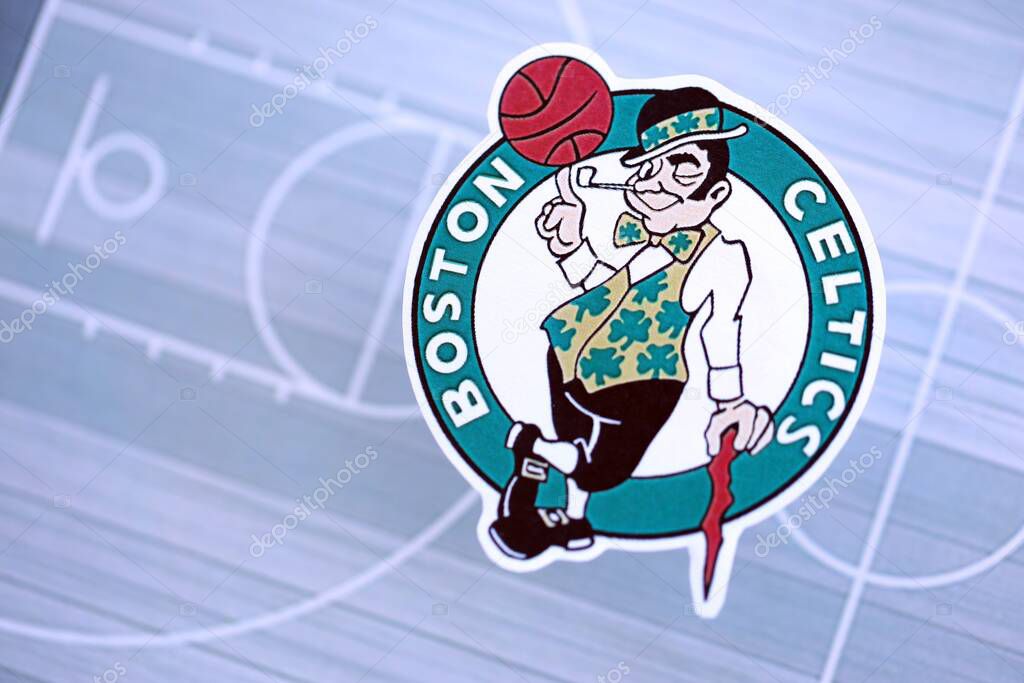 KYIV, UKRAINE - FEBRUARY 23, 2025 Boston Celtics basketball team badge lies on basketball stadium map background banner