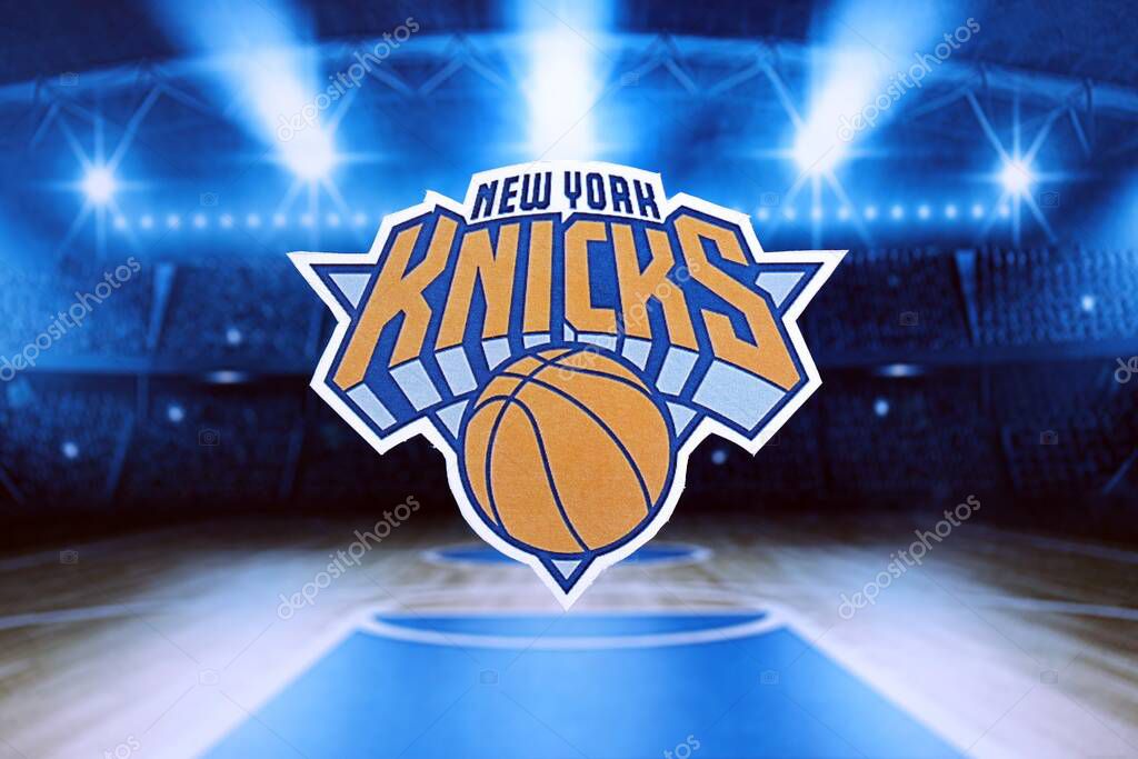 KYIV, UKRAINE - FEBRUARY 23, 2025 New York Knicks basketball team badge lies on basketball stadium background banner