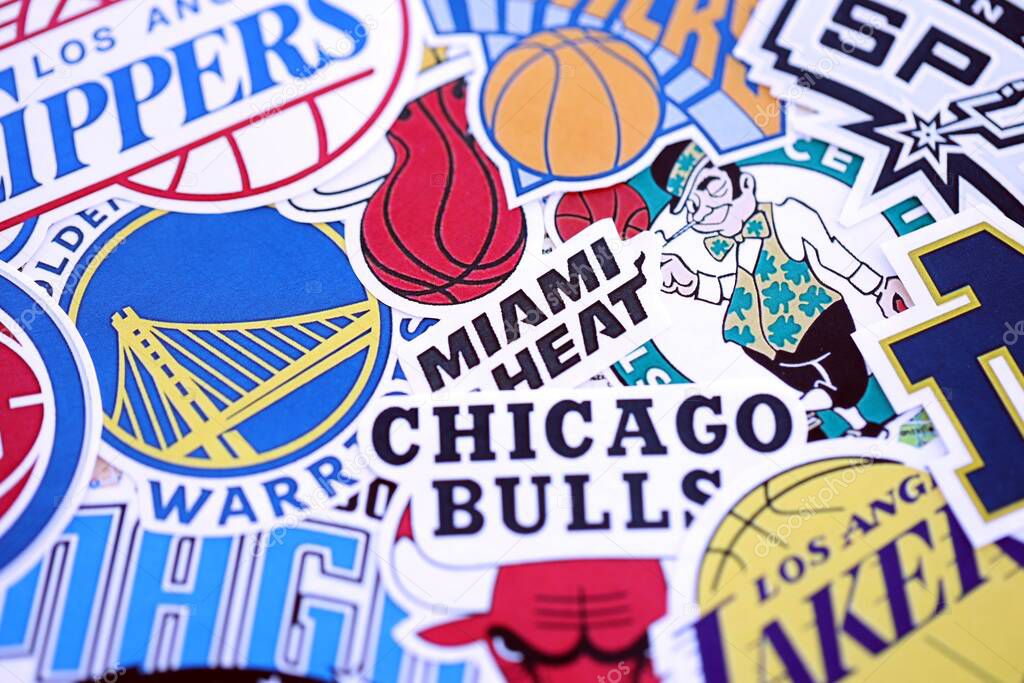 KYIV, UKRAINE - FEBRUARY 23, 2025 Many paper emblems of NBA basketball teams lies in big pile close up