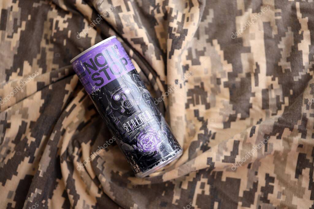 KYIV, UKRAINE - APRIL 19, 2025 Non Stop energy drink with limited edition design of Stalker and character with gas mask on purple can close up