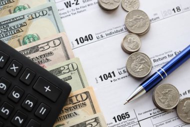 Amerikan Doları. Para banknotları ve vergi formundaki kalem ve hesap makineli paralar boş. Muhasebe ve vergi ödeme dönemi kavramı