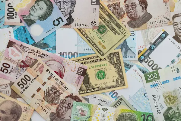 Farklı para birimlerinden ve ülkelerden yüklü miktarda para. Uluslararası nakitin çeşitli arka planında büyük bir yığın var.