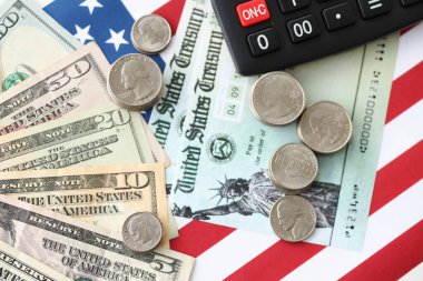 Amerikan doları para ve hesap makinesi Amerikan bayrağına yakın. Para yatırımı konsepti ve vergi ödeme