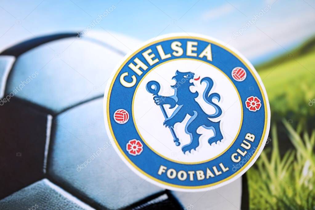 KYIV, UKRAINE - FEBRUARY 23, 2025 Chelsea FC football club badge lies on soccer ball background banner
