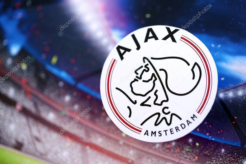 KYIV, UKRAINE - FEBRUARY 23, 2025 AFC Ajax football club badge lies on soccer stadium background banner