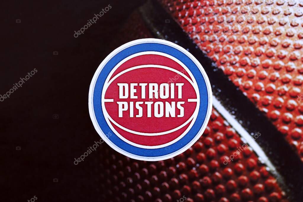 KYIV, UKRAINE - FEBRUARY 23, 2025 Detroit Pistons basketball team badge lies on basketball ball background banner