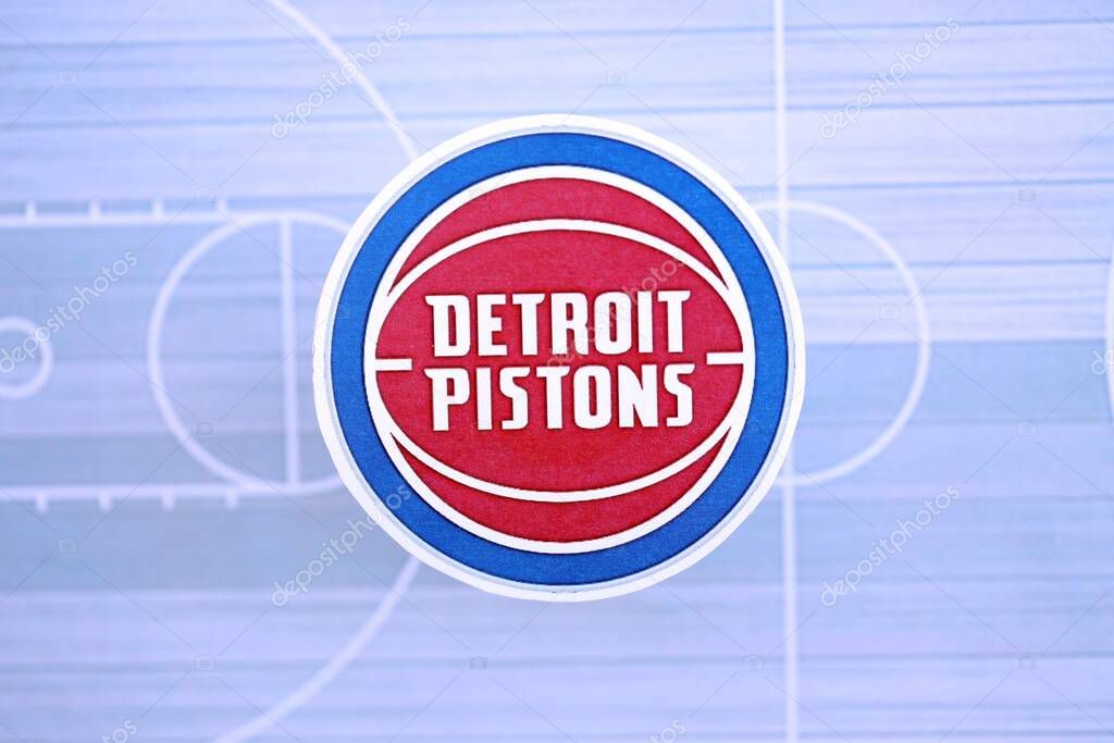 KYIV, UKRAINE - FEBRUARY 23, 2025 Detroit Pistons basketball team badge lies on basketball stadium map background banner