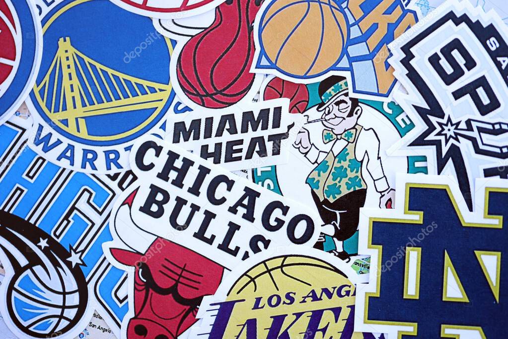 KYIV, UKRAINE - FEBRUARY 23, 2025 Many paper emblems of NBA basketball teams lies in big pile close up