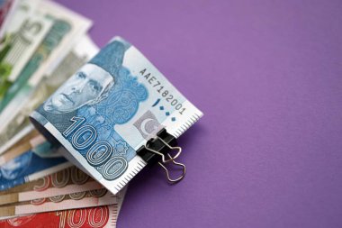Pakistan mor arka planda banknotlar halinde. Pakistan 'ın mevcut para faturaları büyük miktarda masada yatıyor. Pakistan 'da iş ve yatırım kavramı