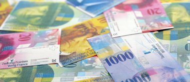 İsviçre frangı banknotları. Mevcut frank para faturaları büyük miktarda masada yatıyor. İş ve yatırım kavramı