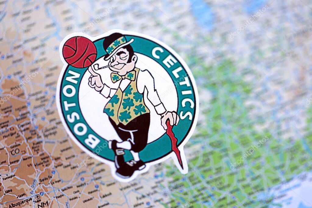 KYIV, UKRAINE - FEBRUARY 23, 2025 Boston Celtics basketball team badge lies on USA map background banner