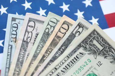 Amerikan doları banknotları ve Amerikan bayrağı kapanıyor. Para yatırımı konsepti ve vergi ödeme