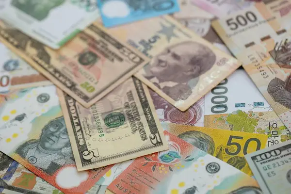 Farklı para birimlerinden ve ülkelerden yüklü miktarda para. Uluslararası nakitin çeşitli arka planında büyük bir yığın var.