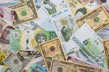 Farklı para birimlerinden ve ülkelerden yüklü miktarda para. Uluslararası nakitin çeşitli arka planında büyük bir yığın var.