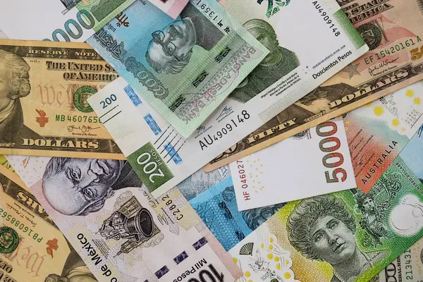 Farklı para birimlerinden ve ülkelerden yüklü miktarda para. Uluslararası nakitin çeşitli arka planında büyük bir yığın var.