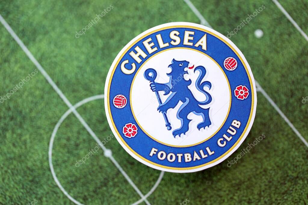 KYIV, UKRAINE - FEBRUARY 23, 2025 Chelsea FC football club badge lies on soccer field background banner