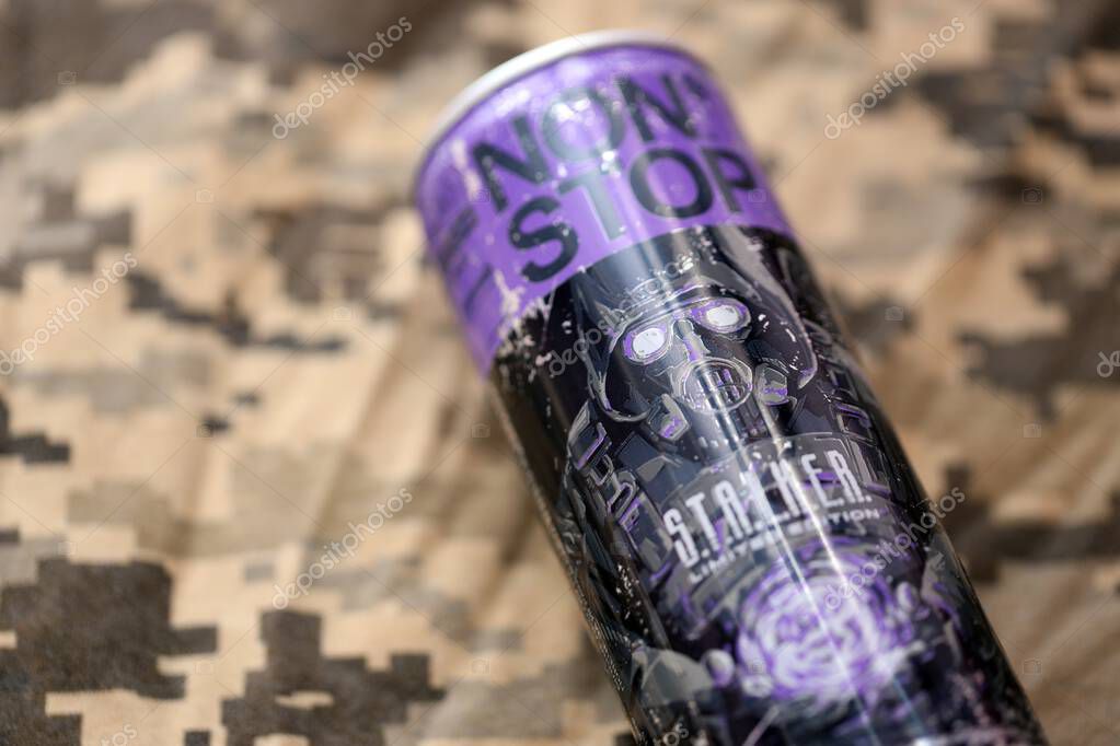 KYIV, UKRAINE - APRIL 19, 2025 Non Stop energy drink with limited edition design of Stalker and character with gas mask on purple can close up