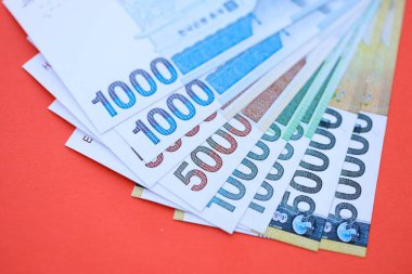 Güney Kore büyük miktarlarda para kazandı. Kırmızı renkli masada yatıyor. Yakın plan. Finans ve bankacılık kavramı