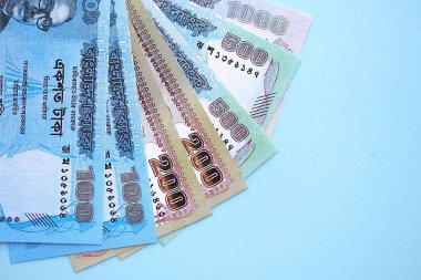 Bangladeşli para banknotları büyük miktarlarda deniz mavisi renkli masaların üzerinde. Finans ve bankacılık kavramı
