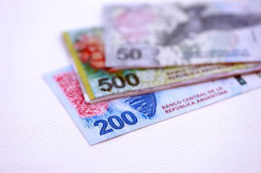 Arjantin pezosu büyük miktarlarda para beyaz masada yakın planda yatıyor. Finans ve bankacılık kavramı