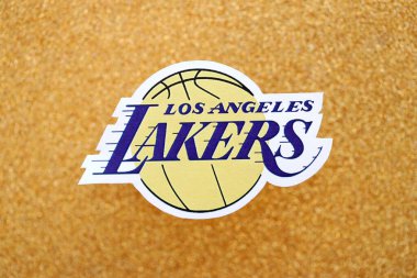 KYIV, UKRAINE - 23 Şubat 2025 Los Angeles Lakers basketbol takımı rozeti altın sarısı parıltılı arka plan pankartıyla uzanır