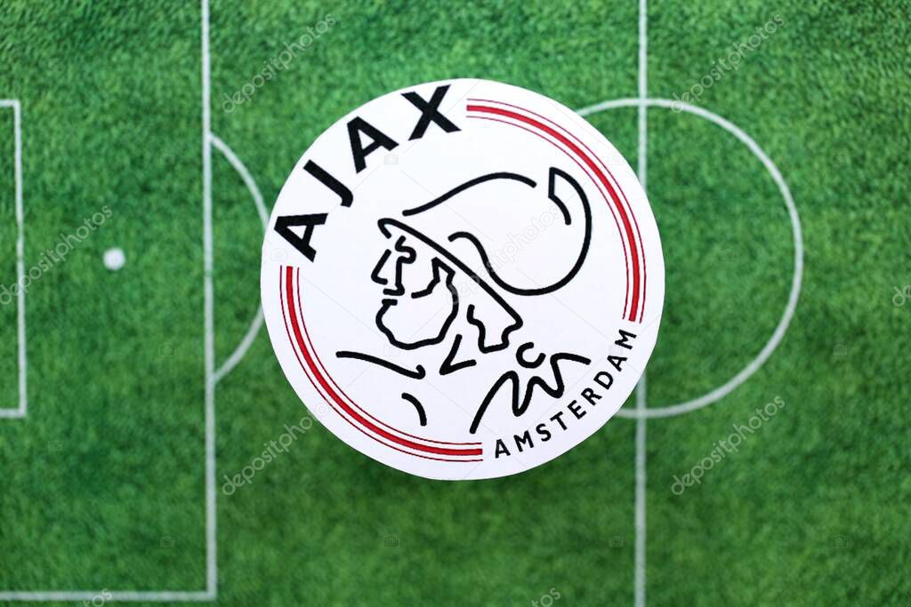 KYIV, UKRAINE - FEBRUARY 23, 2025 AFC Ajax football club badge lies on soccer field background banner