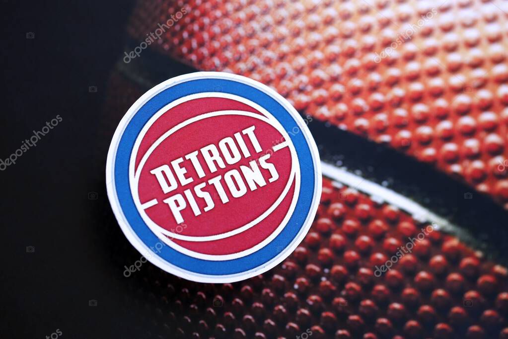 KYIV, UKRAINE - FEBRUARY 23, 2025 Detroit Pistons basketball team badge lies on basketball ball background banner