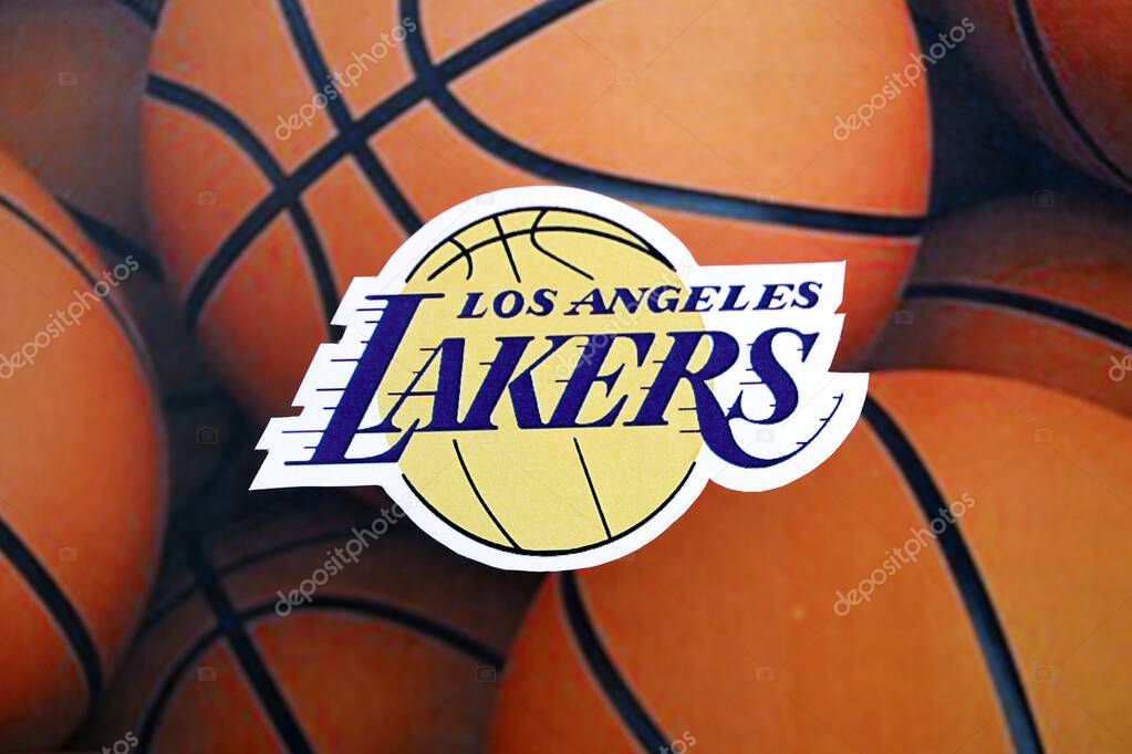 KYIV, UKRAINE - FEBRUARY 23, 2025 Los Angeles Lakers basketball team badge lies on basketball balls background banner