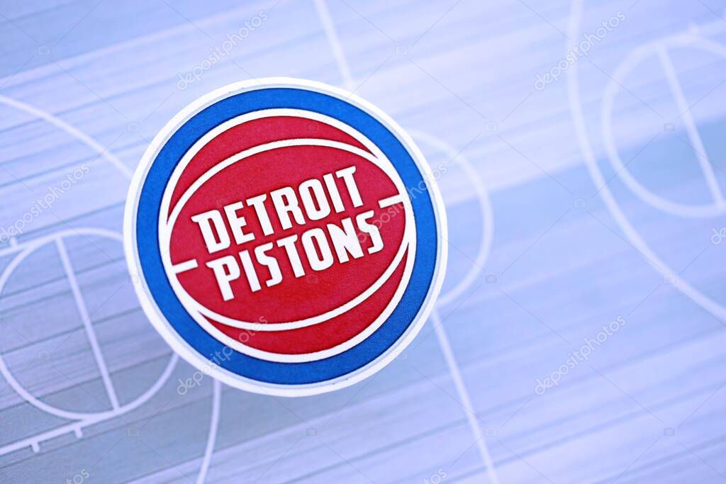 KYIV, UKRAINE - FEBRUARY 23, 2025 Detroit Pistons basketball team badge lies on basketball stadium map background banner