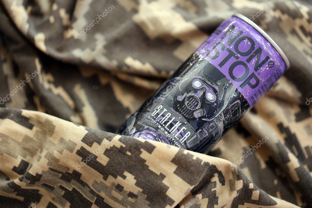 KYIV, UKRAINE - APRIL 19, 2025 Non Stop energy drink with limited edition design of Stalker and character with gas mask on purple can close up