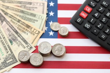 Amerikan doları para ve hesap makinesi Amerikan bayrağına yakın. Para yatırımı konsepti ve vergi ödeme
