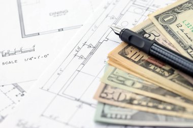 Kalemle birlikte yüklü miktarda Amerikan doları banknotları ve konut projesinin planları yakın plan. Yatırım ve inşaat projesi kavramı