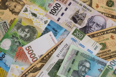 Farklı para birimlerinden ve ülkelerden yüklü miktarda para. Uluslararası nakitin çeşitli arka planında büyük bir yığın var.