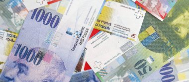İsviçre frangı banknotları. Mevcut frank para faturaları büyük miktarda masada yatıyor. İsviçre 'de iş ve yatırım kavramı