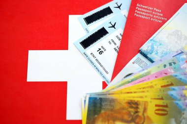 İsviçre frangı banknotları ve bayrak üzerinde biletleri olan pasaport. Mevcut para faturaları ve biyometrik geçiş bayrağın üzerinde. İsviçre 'de seyahat ve tatil kavramı