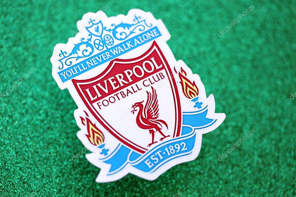 KYIV, UKRAINE - FEBRUARY 23, 2025 Liverpool UK FC football club badge lies on emerald green glitter background banner