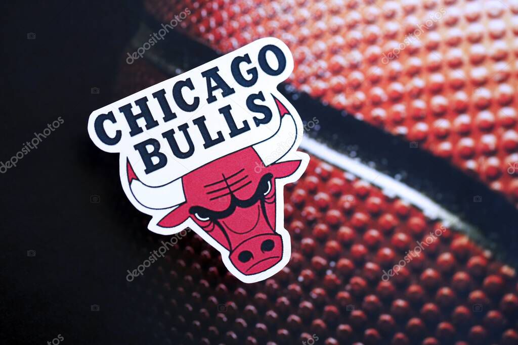 KYIV, UKRAINE - FEBRUARY 23, 2025 Chicago Bulls basketball team badge lies on basketball ball background banner