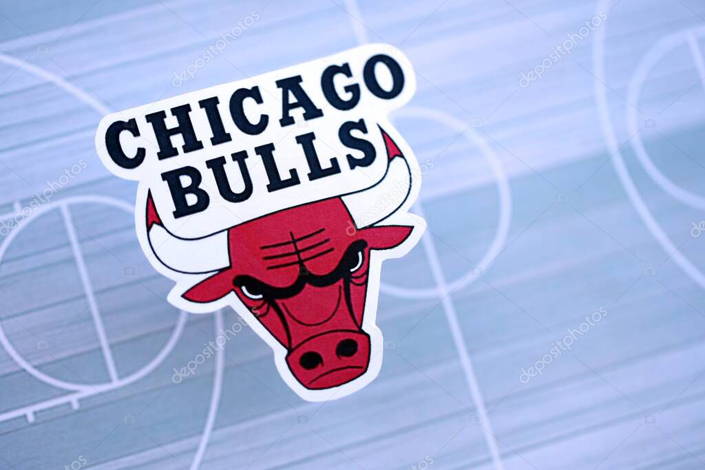KYIV, UKRAINE - FEBRUARY 23, 2025 Chicago Bulls basketball team badge lies on basketball stadium map background banner