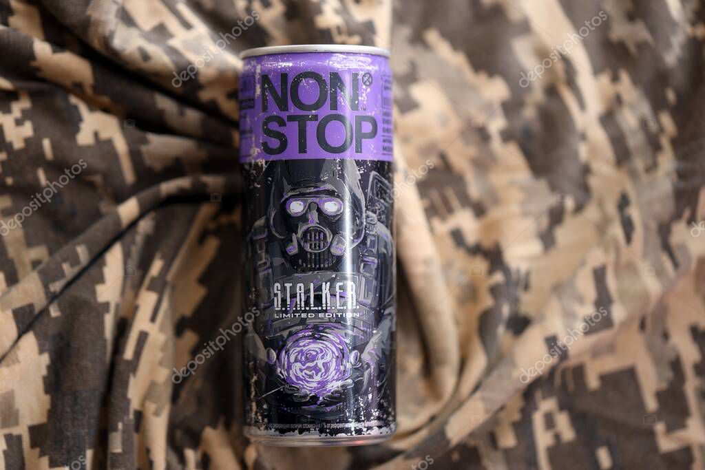 KYIV, UKRAINE - APRIL 19, 2025 Non Stop energy drink with limited edition design of Stalker and character with gas mask on purple can close up