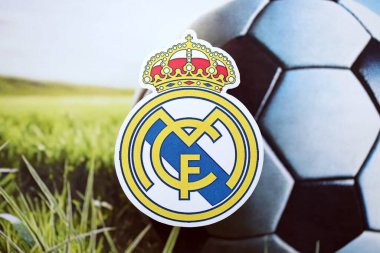 KYIV, UKRAINE - 23 Şubat 2025 Real Madrid CF futbol kulübü rozeti futbol arka planında yer alıyor