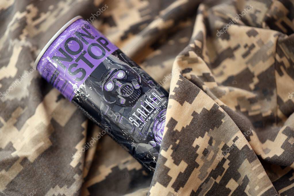 KYIV, UKRAINE - APRIL 19, 2025 Non Stop energy drink with limited edition design of Stalker and character with gas mask on purple can close up