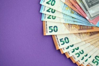 Avrupa para birimi banknotlarının büyük bir kısmı mor renkli masaya yakın. Avrupa 'da iş ve gelir kavramı