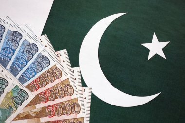 Pakistan 'ın bayrak geçmişi üzerine Pakistan banknotları. Pakistan 'ın mevcut para faturaları büyük miktarlarda pankartta yatıyor. Pakistan 'da ekonomi ve ticaret kavramı