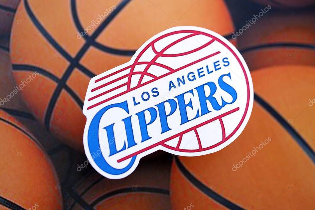KYIV, UKRAINE - FEBRUARY 23, 2025 Los Angeles Clippers basketball team badge lies on basketball balls background banner