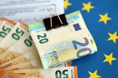 Avrupa para birimi banknotları vergi formu ve Avrupa sendikası mavi bayrağına yakın. Avrupa 'da vergilendirme ve muhasebe kavramı